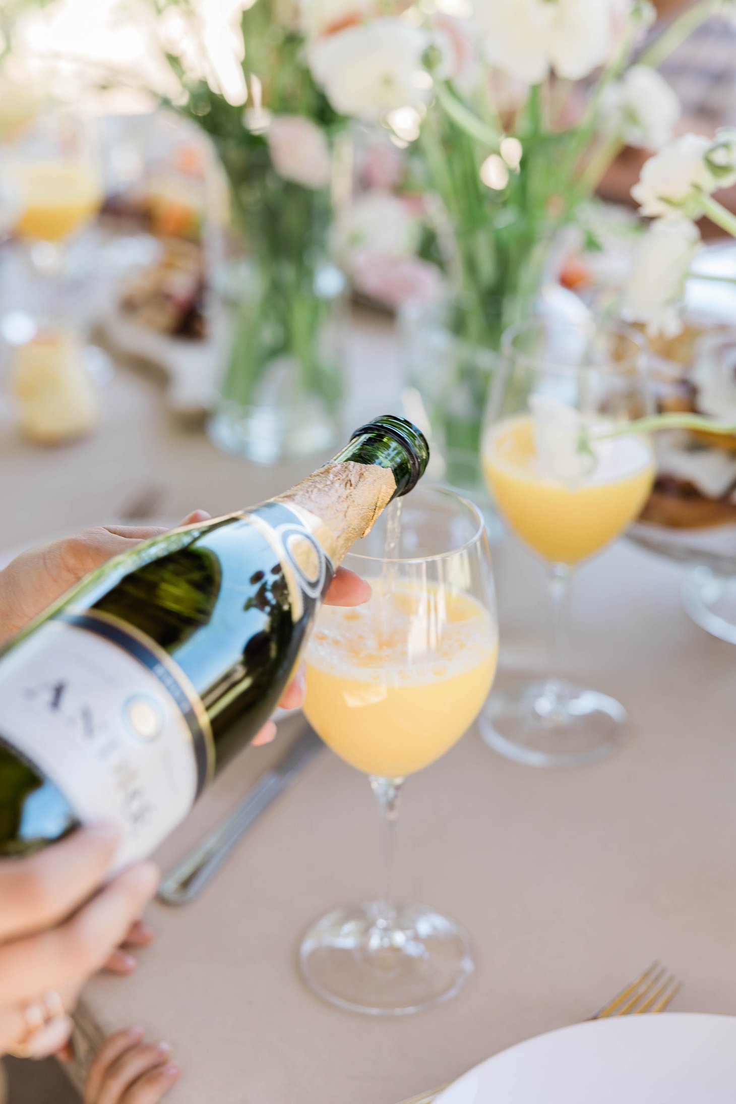 Person Pouring Champagne in a Glass